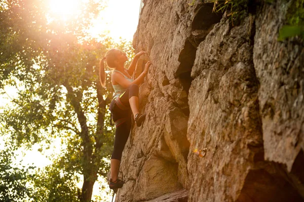 Bella donna che si arrampica sulla roccia a Foggy Sunset in montagna. Avventura e sport estremi Concetto — Foto Stock