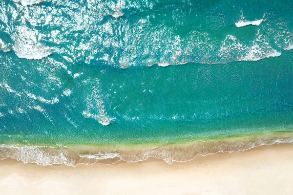 Beach and waves from top view. Turquoise water background from top view. Travel concept and idea