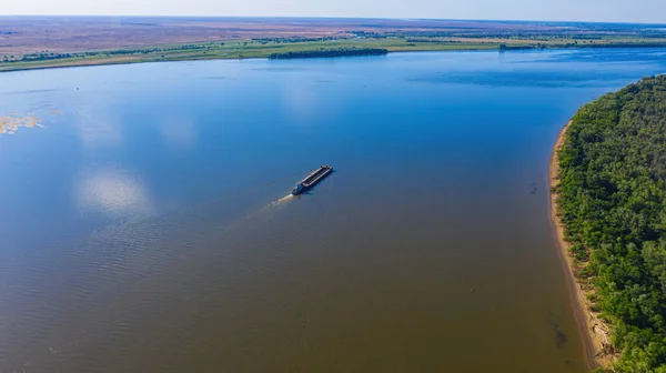 Una barcaza o buque de carga seca va aguas arriba del río Volga, cerca de Astracán. Fotografía aérea — Foto de Stock