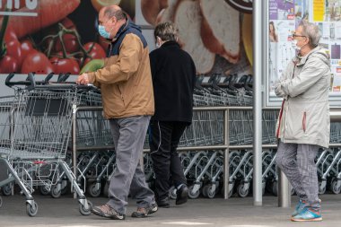 PECS - 27 Mayıs 2020 tarihinde Macaristan 'ın Pecs kentinde yaşlı insanlar alışverişe gider. Coronavirus salgını sırasında herkes maske takmak zorundadır.