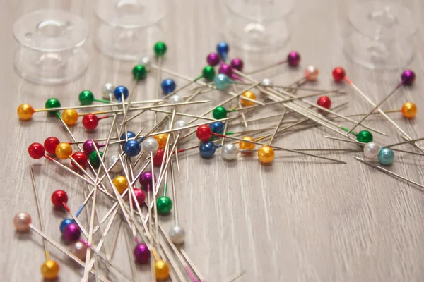 colorful pile of straight pins on white background