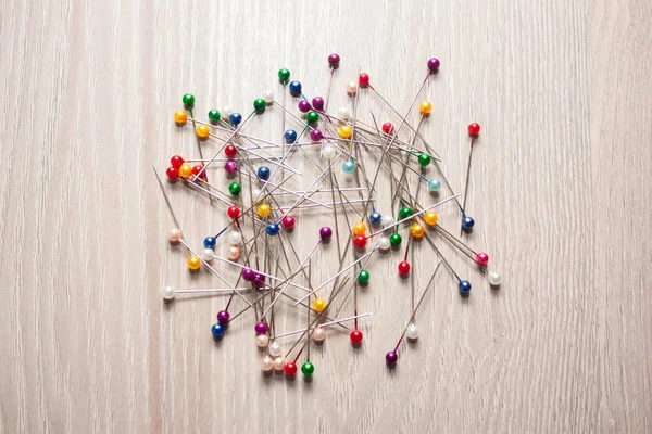 colorful pile of straight pins on white background