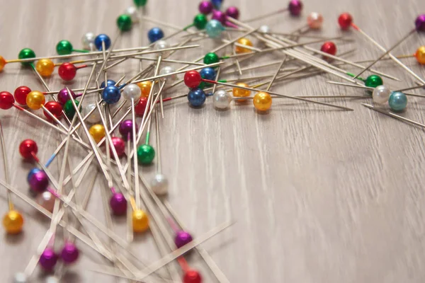 colorful pile of straight pins on white background