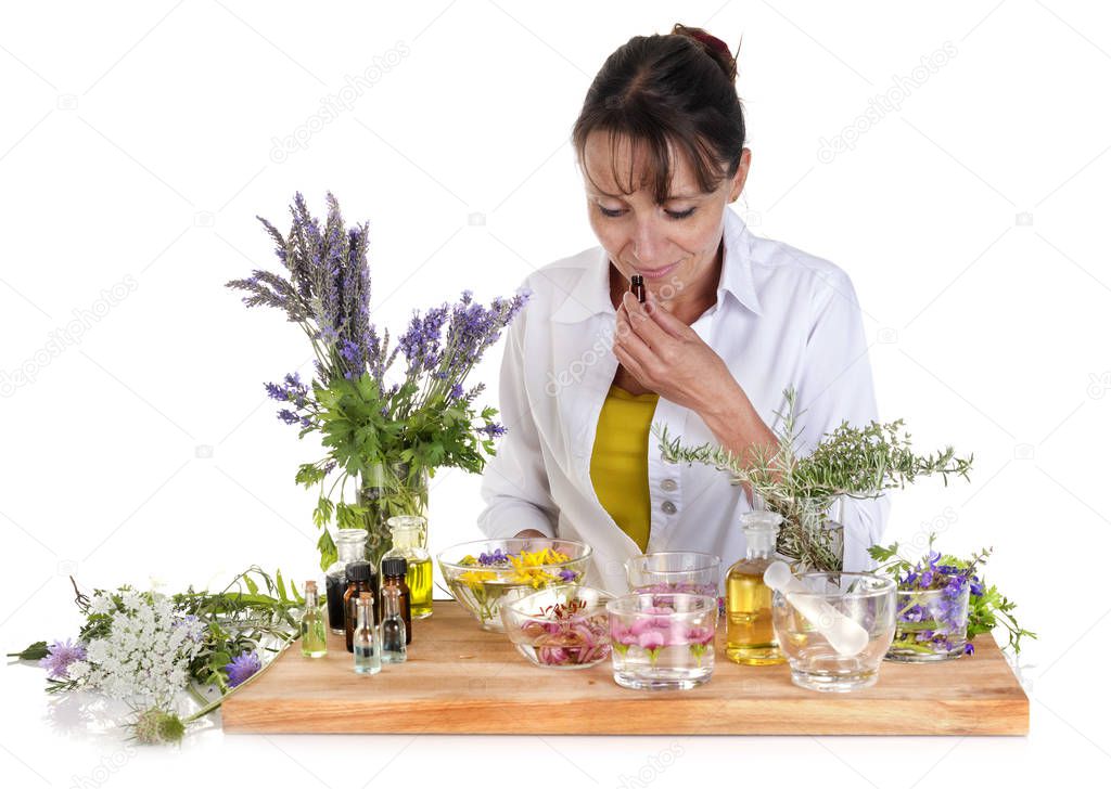 woman and essential oils in front of white background