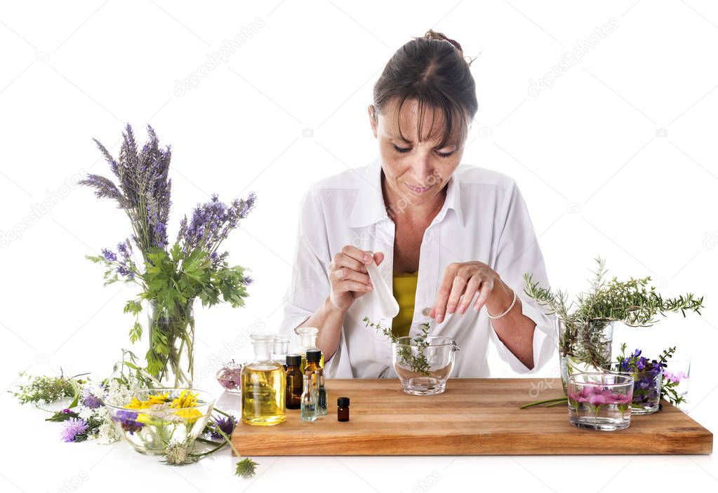 woman and essential oils in front of white background