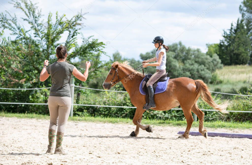  riding girl are training her horse in equestrian center