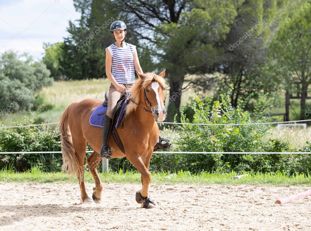  riding girl are training her horse in equestrian center