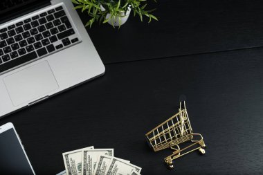 Altın sepeti, nakit ve becerikli alet üstünde siyah bir tablo.