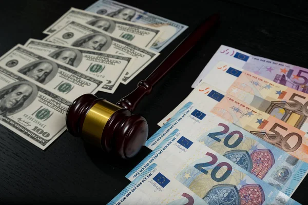 Judges gavel on the background of euro and dollar bills — Stock Photo, Image