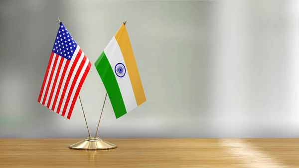 American and Indian flag pair on a desk over defocused background
