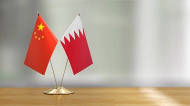 Defokus arka plan üzerinde bir masada Çin ve Bahreyn bayrak çifti 