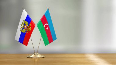 Azerbaycan ve Rus bayrak çifti dağılmış arka plan üzerinde bir masada 