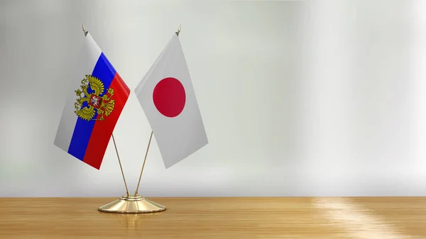 俄罗斯和日本国旗搭配在一张桌子上 背景分散 — 图库照片