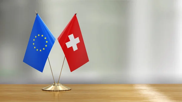 União Europeia Bandeira Suíça Emparelham Uma Mesa Sobre Fundo Desfocado — Fotografia de Stock