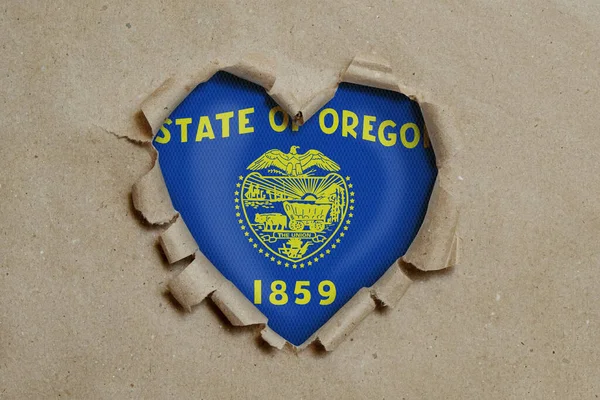 Heart Shaped Hole Torn Paper Showing Oregon Flag — Stock Photo, Image