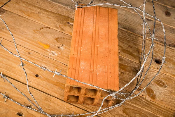 Orange Brick Barbed Wire Wooden Background Social Issues Concept — Stock Photo, Image