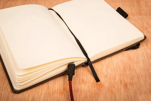 Klein Notaboekje Met Batterij Laadkabel Tafel — Stockfoto