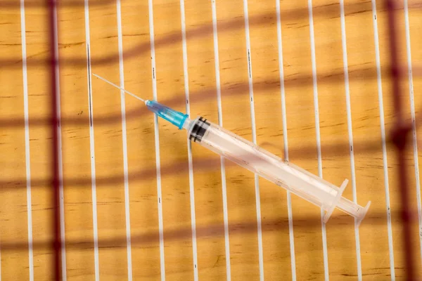 Syringe in a cage — Stock Photo, Image