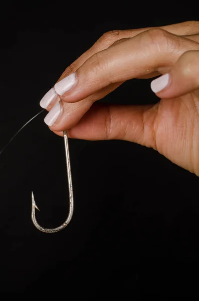 Hand holding a hook — Stock Photo, Image