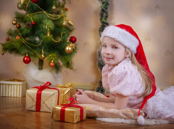 Cute Girl Santa Hat Dreaming Christmas Tree Gifts — Stock Photo, Image