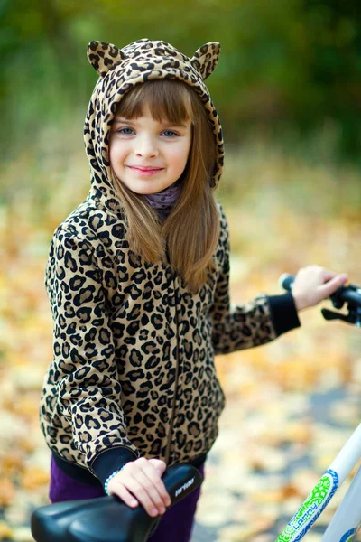 Pretty girl in a spotted jacket in a hood with ears and jeans st — Stock Photo, Image