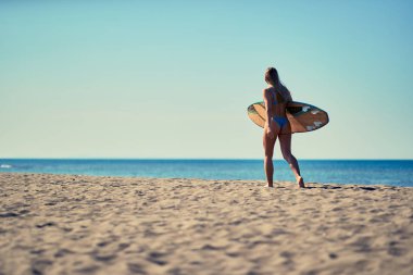 Güzel kadın sörfçü having fun yaz aylarında sahilde
