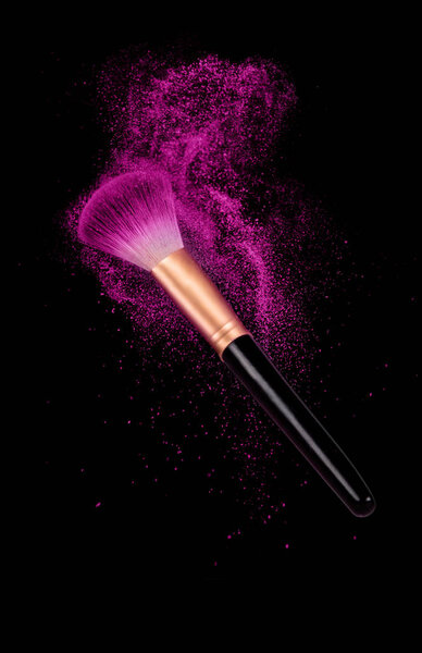 make-up brush with powder dust on black 