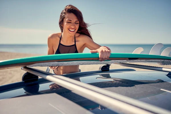 サーフィンのための準備をビーチで若い美しいサーファーガール — ストック写真