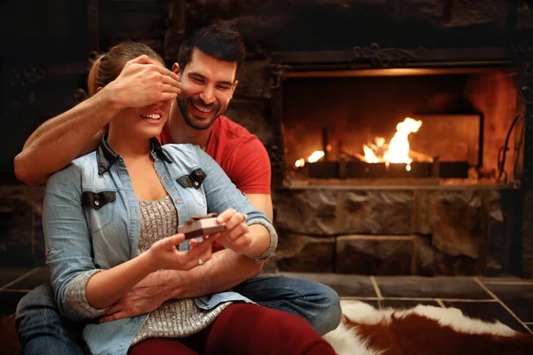 Woman Hides Eyes Receiving Gift Man Surprise Holiday — Stock Photo, Image