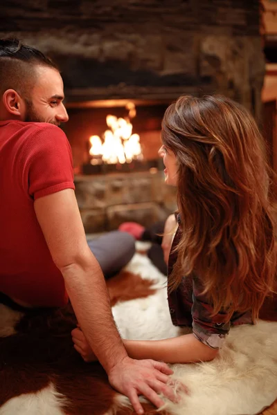 Couple in love in mountain together near fireplace