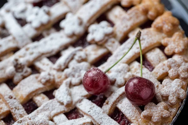 close up homemade cherry pie with and ripe two cherry