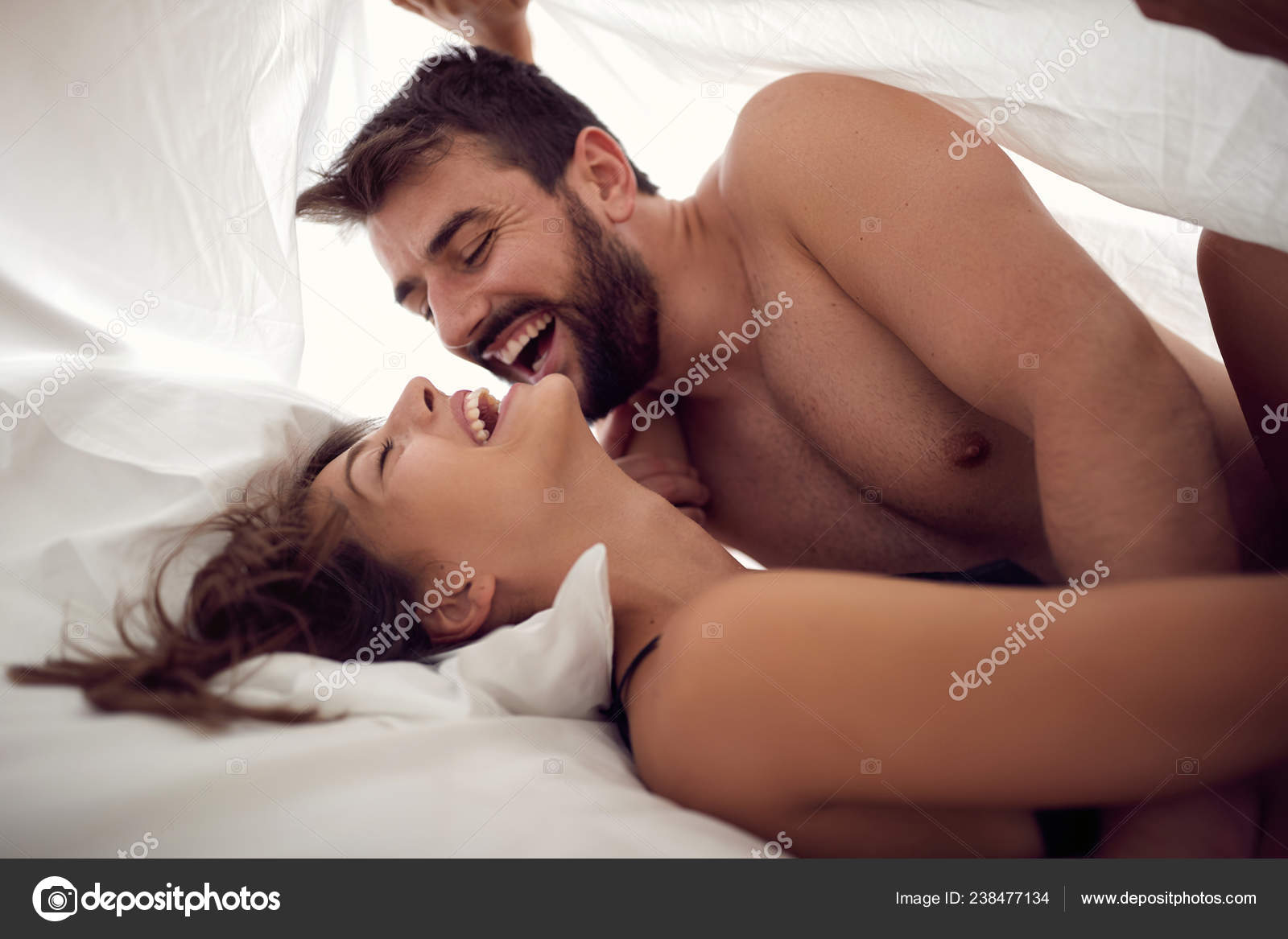 Man And Woman Making Love In Bed