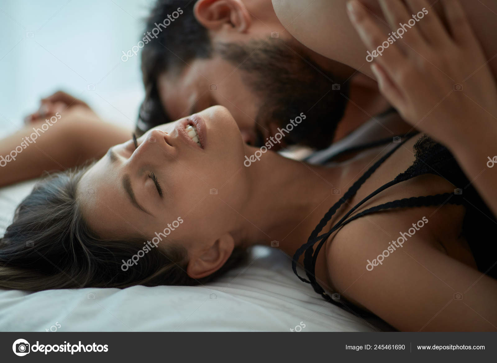 Young Couple Making Love Having Passionate Sex Bed Enjoying Pleasant Stock Photo by ©luckybusiness 245461690 image