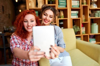 İki güzel kızlar kendilerini fotoğraf çekme gülümseme