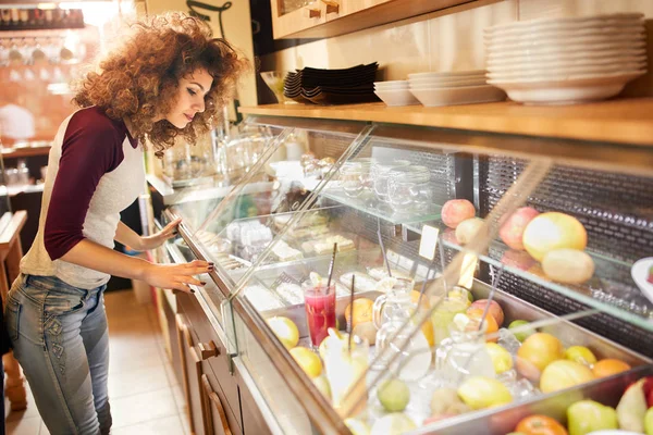Curly Salesgirl Looking Showcase Fresh Fruit — Stock Photo, Image