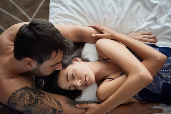 Top view of sexy couple being intimate in bed — Stock Photo, Image