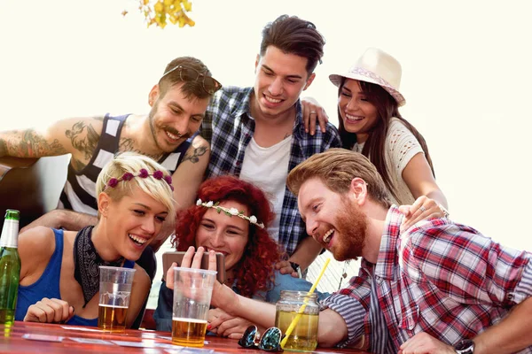 Society laughing while watching something on mobile phone — Stock Photo, Image