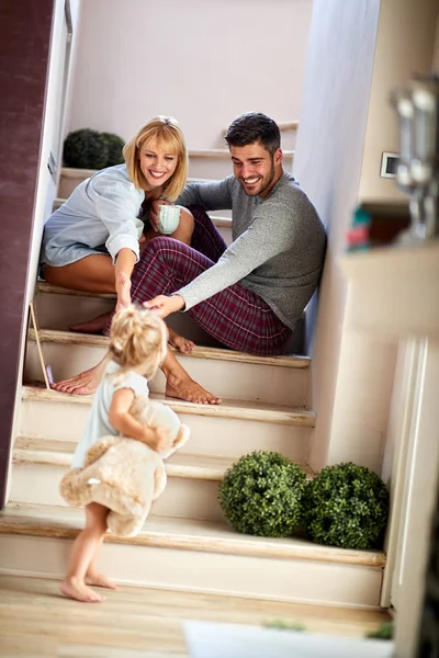 Girl with parents playing and holding teddy bear — Stock Photo, Image
