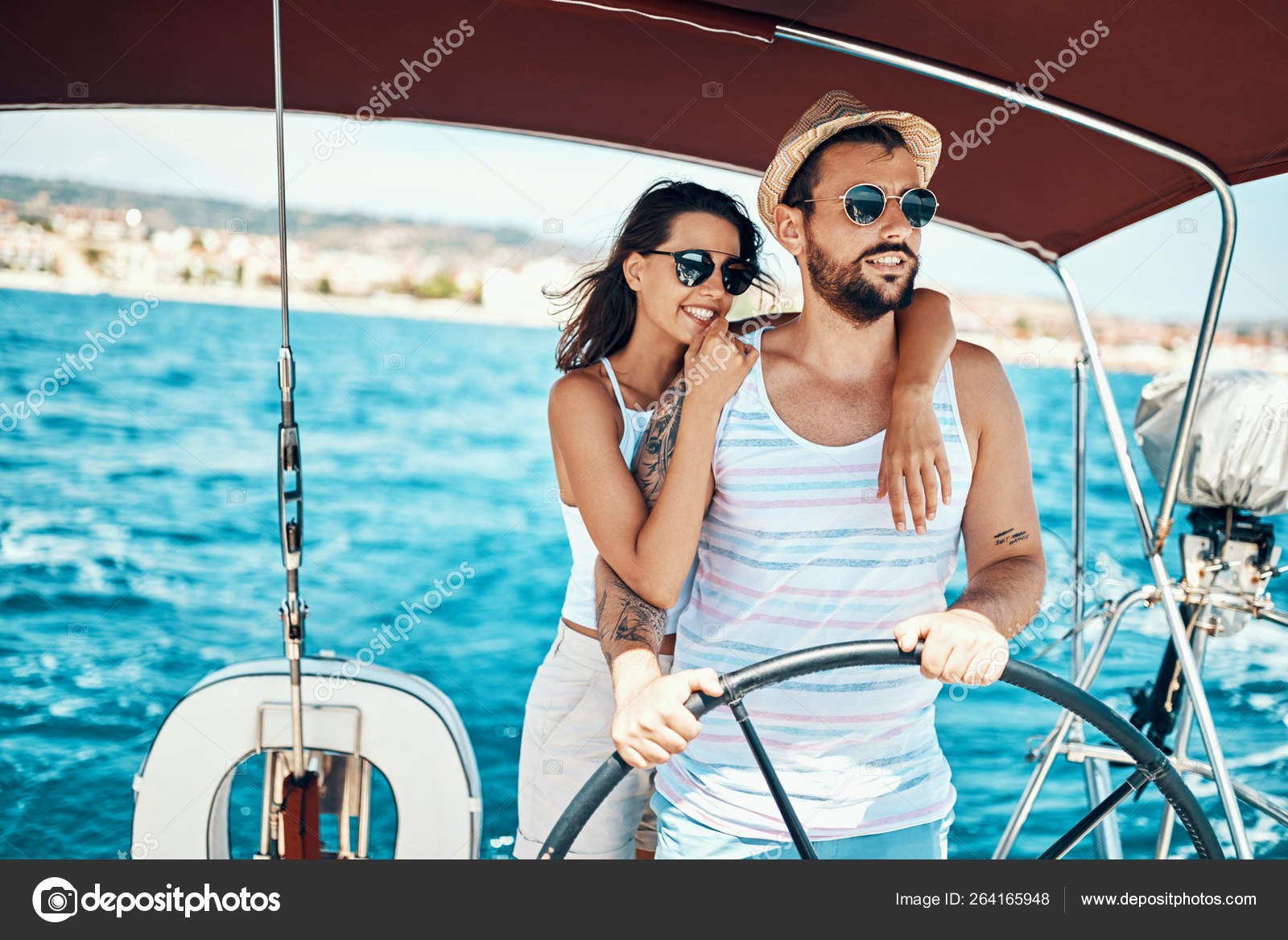 Romantic couple on a yacht enjoy bright sunny day on vacation