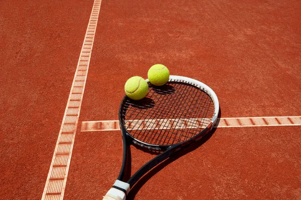 Close up of tennis balls on racket — Stock Photo, Image