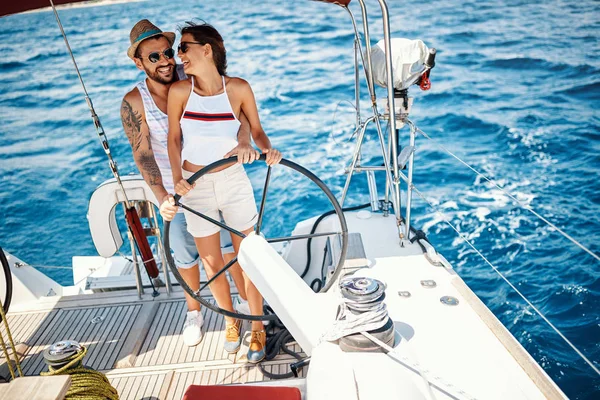 Happy couple on the luxury yacht enjoying together