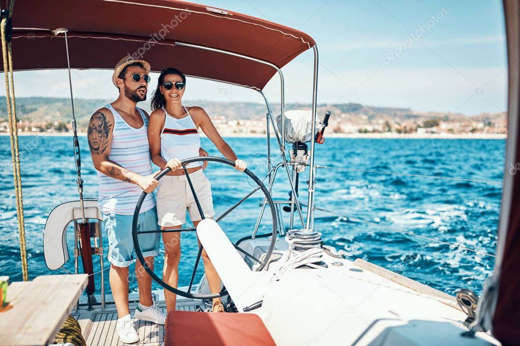 Couple in love on a sail boat in the summer
