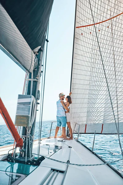 Young lovers spending happy time on a yacht at sea — Stock Photo, Image