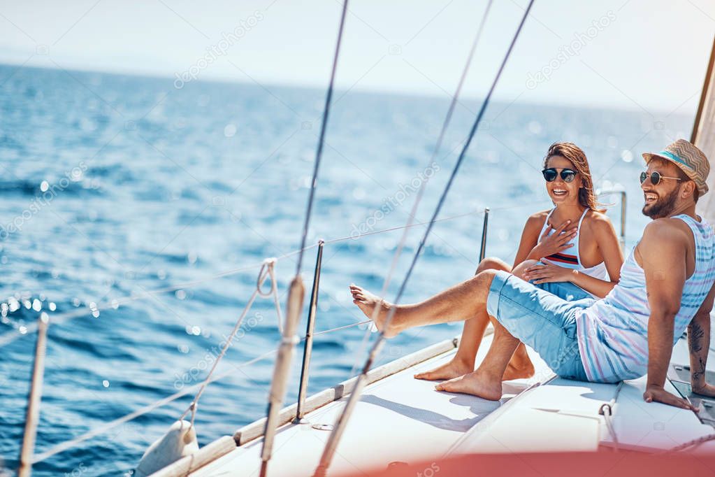 Romantic couple spending time together and relaxing on yacht
