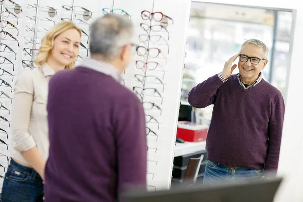 Man look in mirror model of frame glasses — Stock Photo, Image