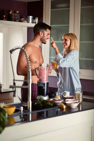 Couple in kitchen having fun