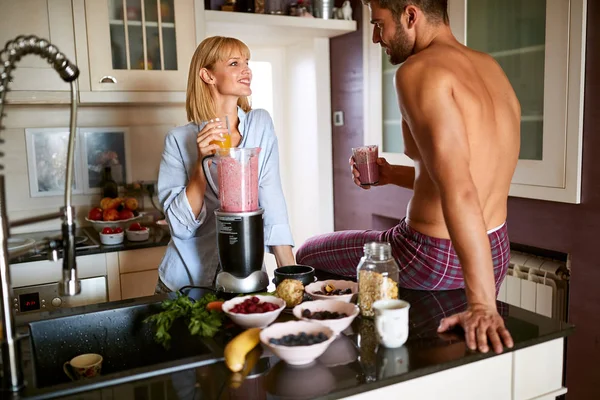 Young cute female with male in kitchen — Stock Photo, Image