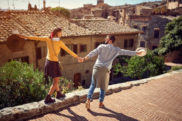 Young couple at the Italy - tourists couple visiting Toscana