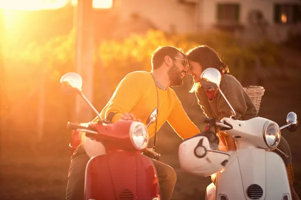 Romantic man and woman riding on a scooter in European — Stock Photo, Image