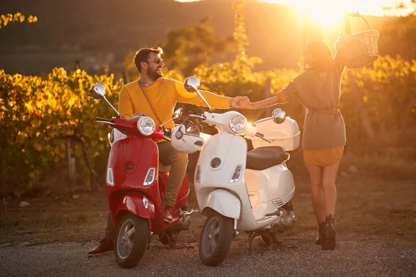 Romantic man and woman riding on a scooter in European on vacation — Stock Photo, Image